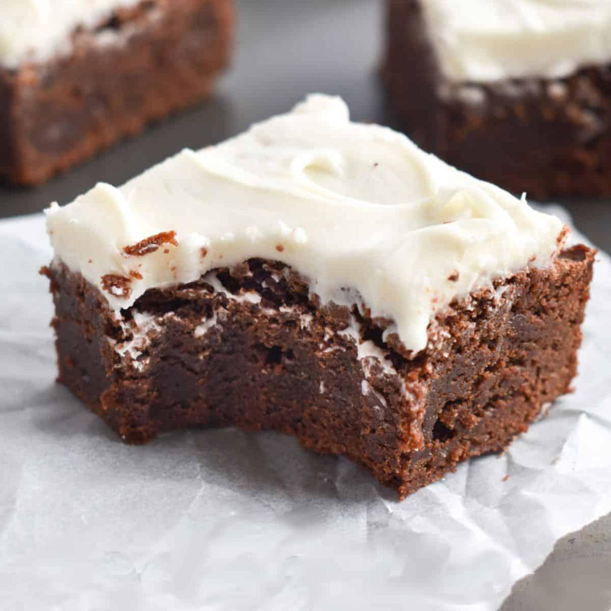  Decadent coffee brownies with a swirl of cream cheese frosting on top.