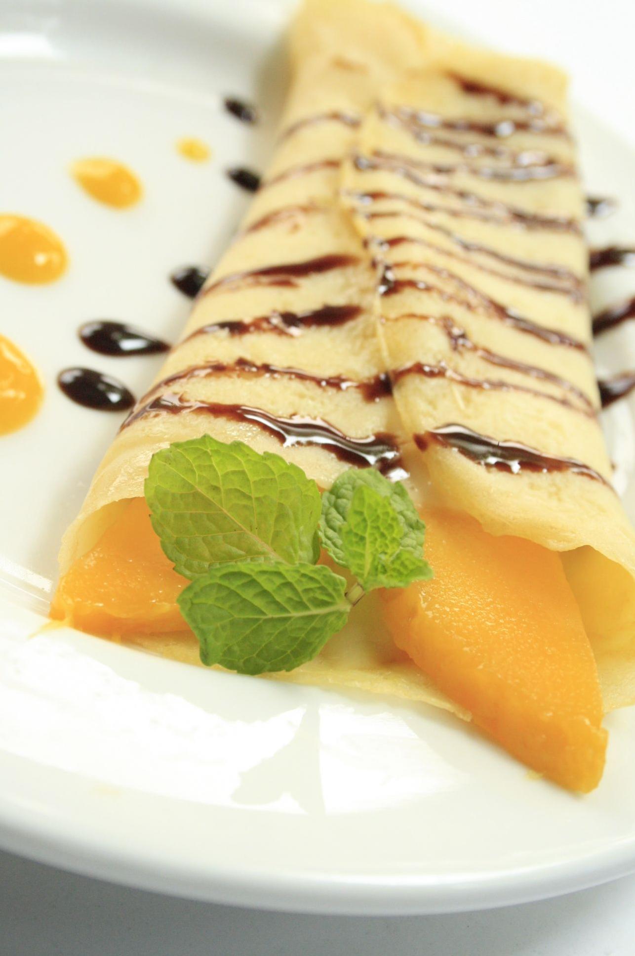  Savor the sweet and tangy flavors of our Mango Espresso Crepes